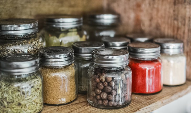 various spices stored in glass jars containers