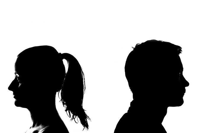 The profile silhouette of a man and woman looking in opposite directions