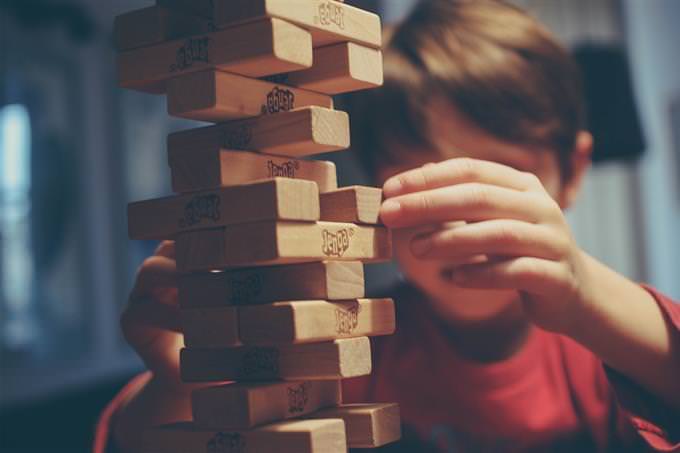 A boy playing Jenga