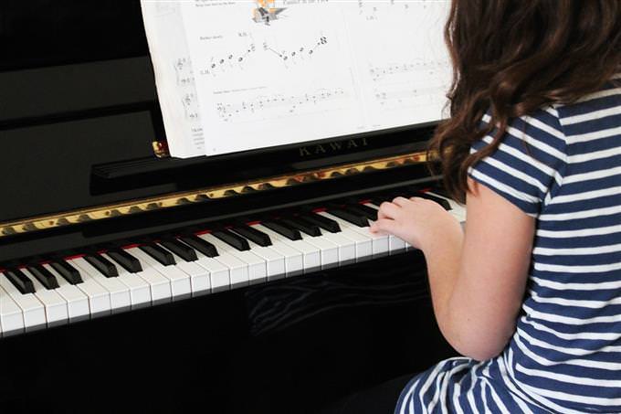 A girl playing on a piano