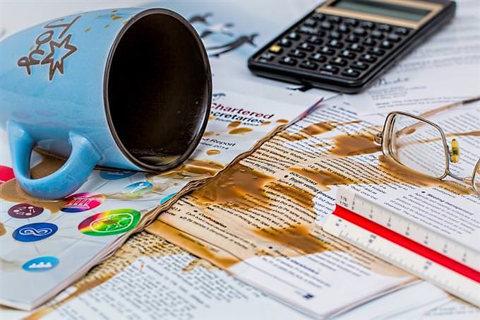 Coffee lying on a desk full of documents