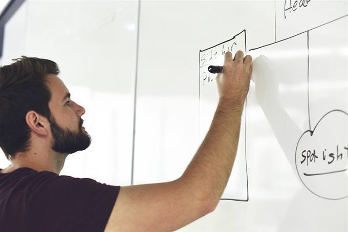 A man writing on a blackboard