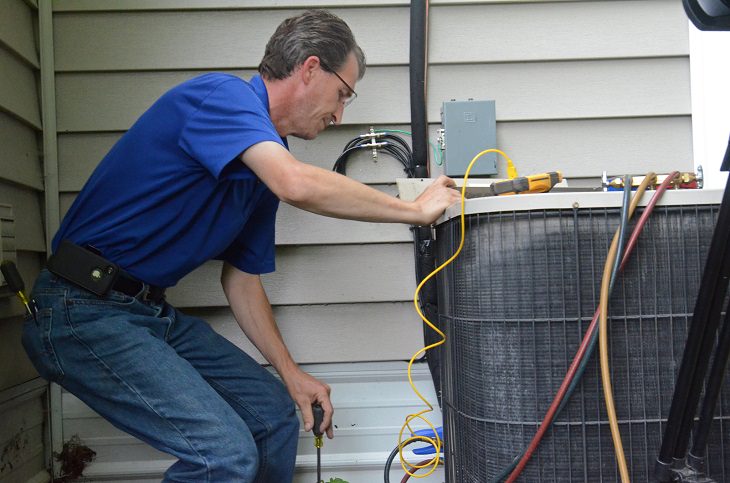 a professional cleaning the filter of the air conditioner