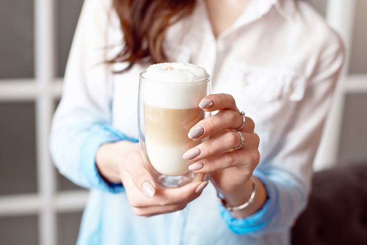 Plant Milks Suitable for Every Task woman holding a soy latte