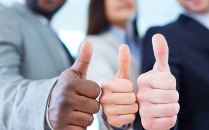two men and woman giving a thumbs up