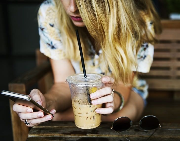 bad habits for skin and hair woman drinking iced latte