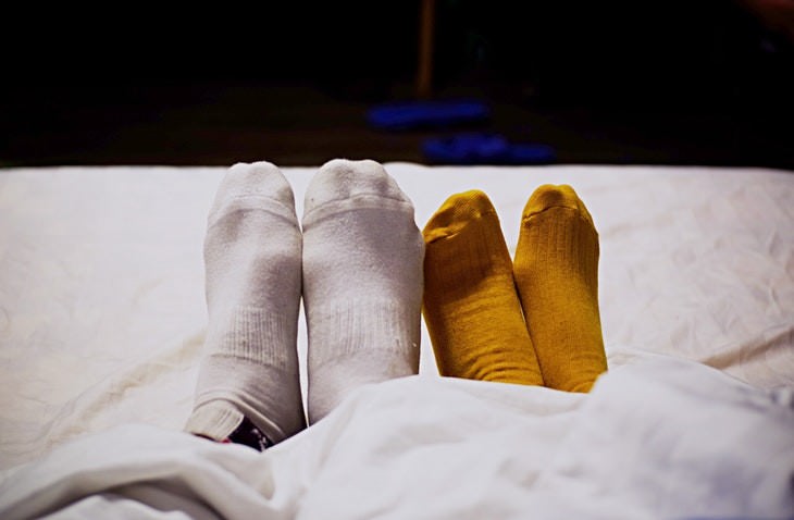 weird beneficial habits couple's feet wearing socks