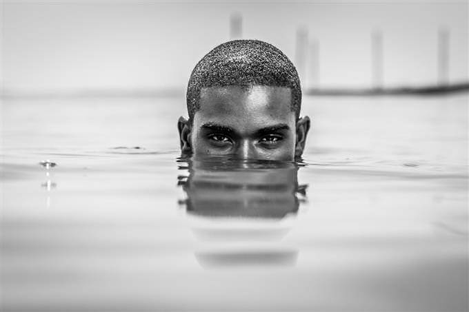 man with half face underwater