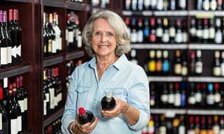 wine guide: lady holding wine bottles