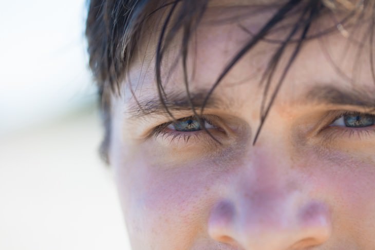 Habits Bad for Eyes closeup of a man squinting at the sun