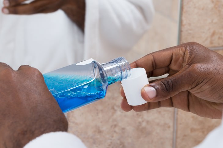 mouthwash dangers man pouring some mouthwash