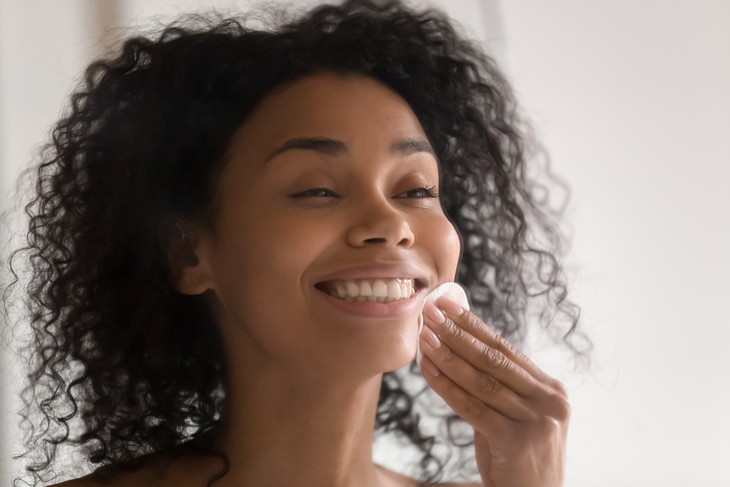 rose water woman applying toner