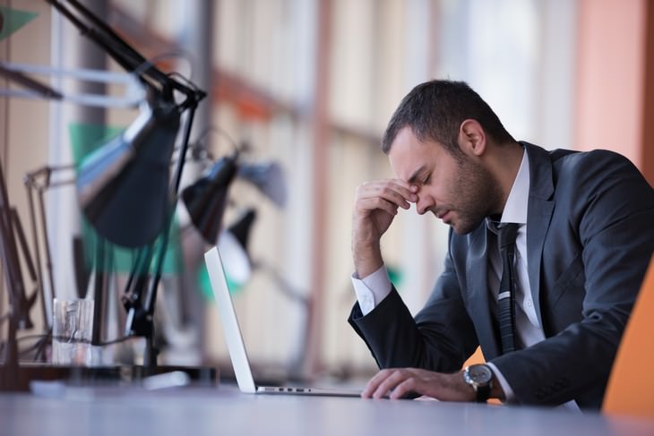 rose water man with headache at work