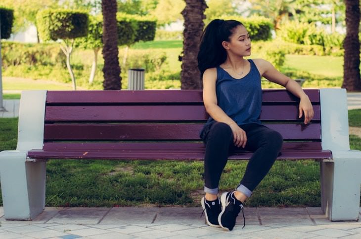 health myths of the 2010's woman sitting on a bench in the park