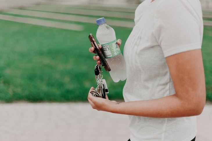 health myths of the 2010's woman carrying a bottle of water and keys