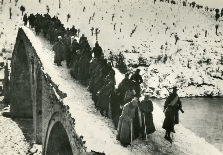 historical photos: The 71-year-old Serbian king, Peter I, crosses the River Drin during the withdrawal of the Serbian army during World War I - December 1915.