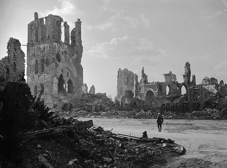 historical photos: An Austrian soldier looks at the ruins of the canvas hall, from one of the largest commercial buildings built in the Middle Ages, in Eper, Belgium - September 3, 1917.