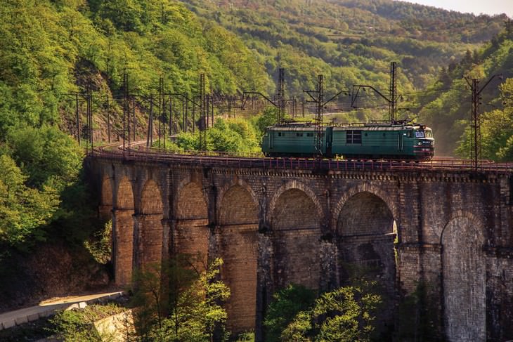 Georgia natural beauty:A train passing an old bridge in Kharagauli