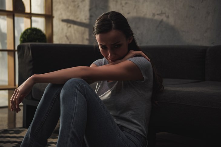 depression myths depressed woman crying near the couch