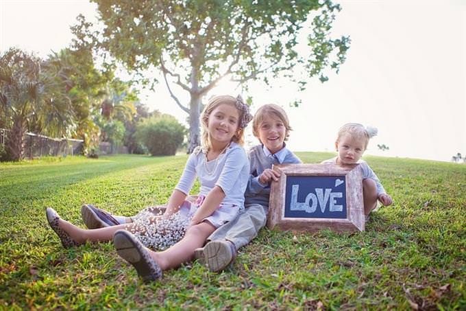 quiz kids on grass holding a love sign