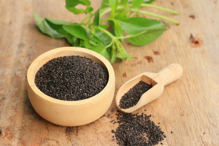 basil seeds health benefits a bowl of seeds and basil leaves