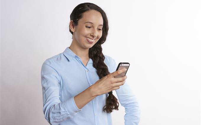 test Woman looking at smartphone and smiling