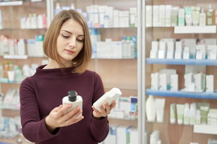 misleading skincare marketing claims woman choosing shampoo