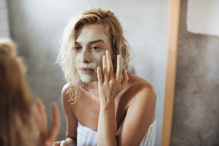 misleading skincare marketing claims woman applying a mask