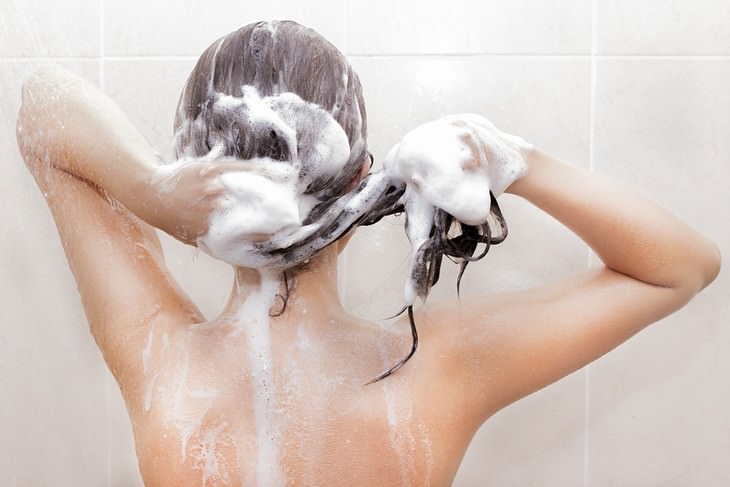 habits that cause hair loss woman shampooing washing her hair