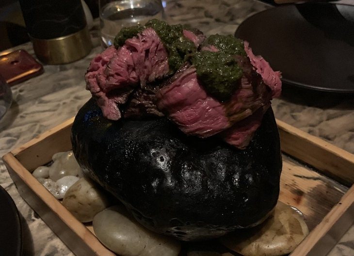 Pretentious food presentations: steak on a rock