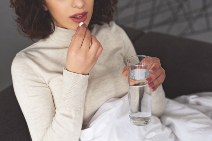 daily aspirin intake woman taking a pill