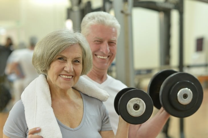 exercising at an older age woman and man at the gym