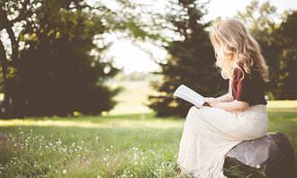 woman sitting on rock outdoors