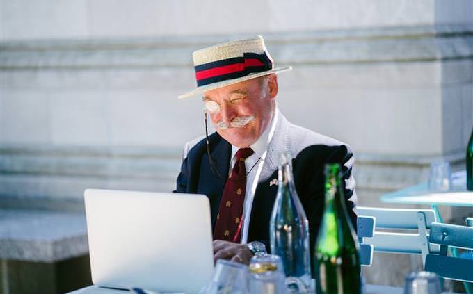 quiz: nicely dressed senior man writing on typewriter