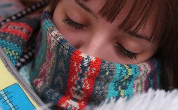 woman with a scarf on her lower face