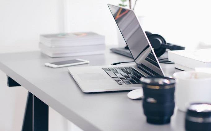 table with a laptop on it and other office tools