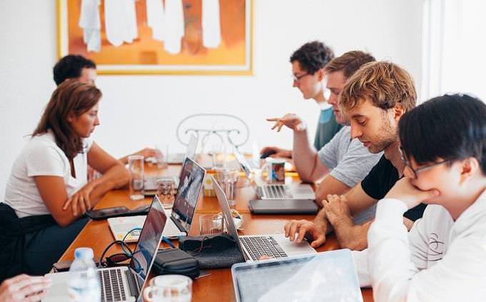 team of workers with laptops