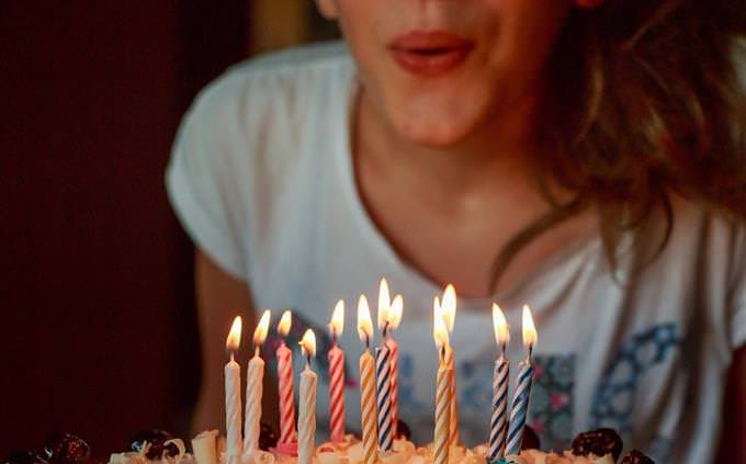 girl blowing out birthday candles