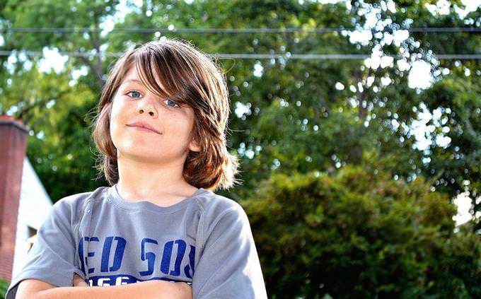 boy standing with arms crossed