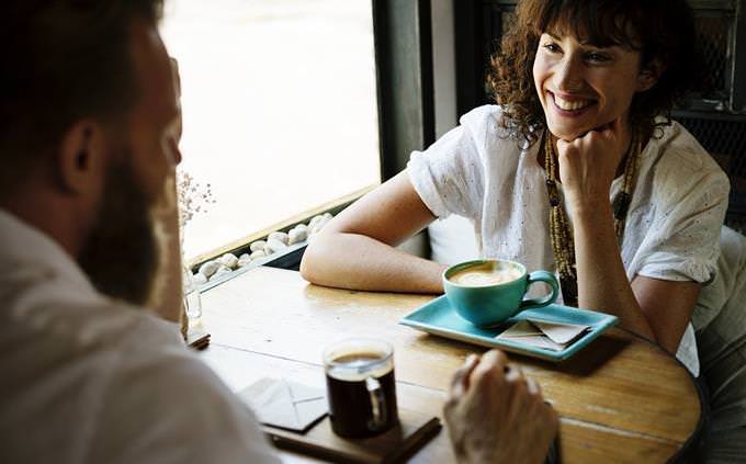 woman talks to man and smiles