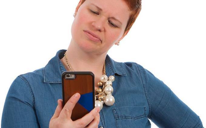a woman looking at her phone inquisitively