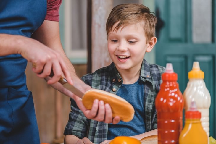 foods safe to eat past expiration date boy waiting for his dad to make him a hot dog 