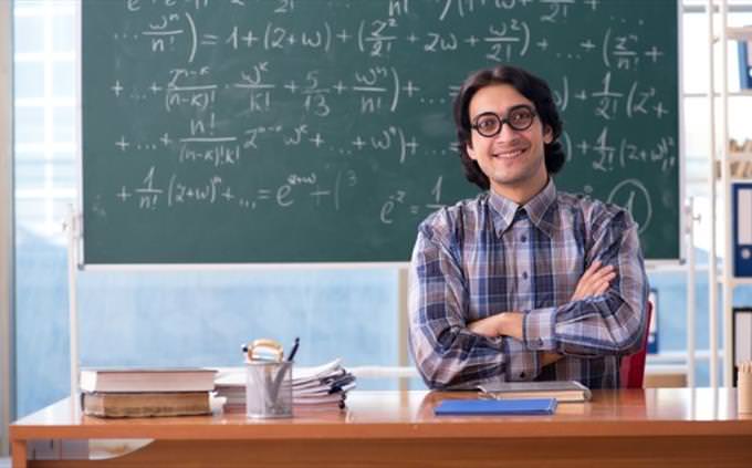 Math quiz: math teacher in front of blackboard with equations