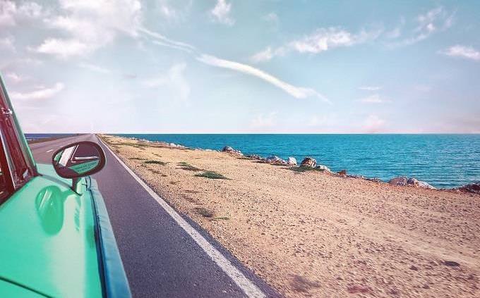 Car on a road near a beach