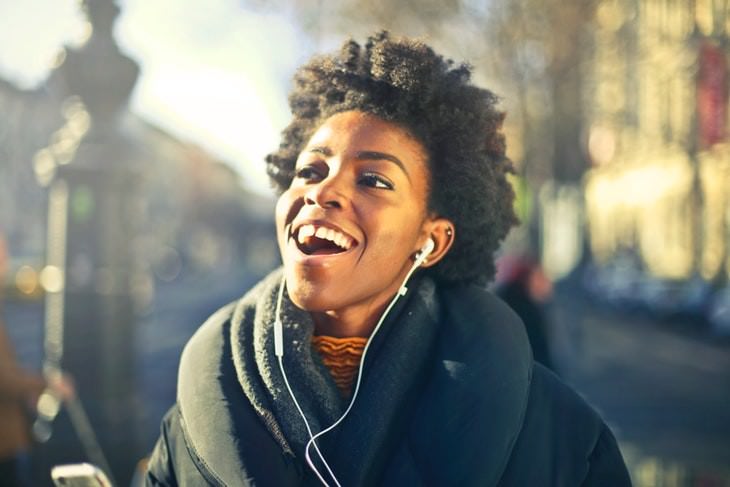 irrelevant slang happy woman listening to music in headphones