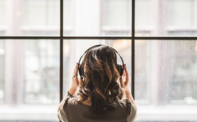 Woman with earphones from the back