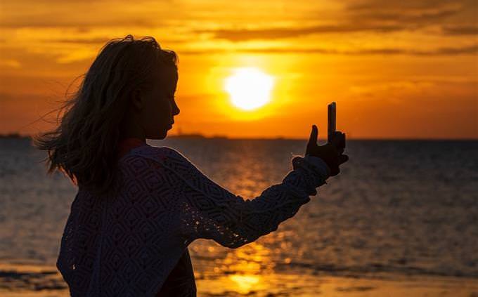 woman taking a selfie on the beach