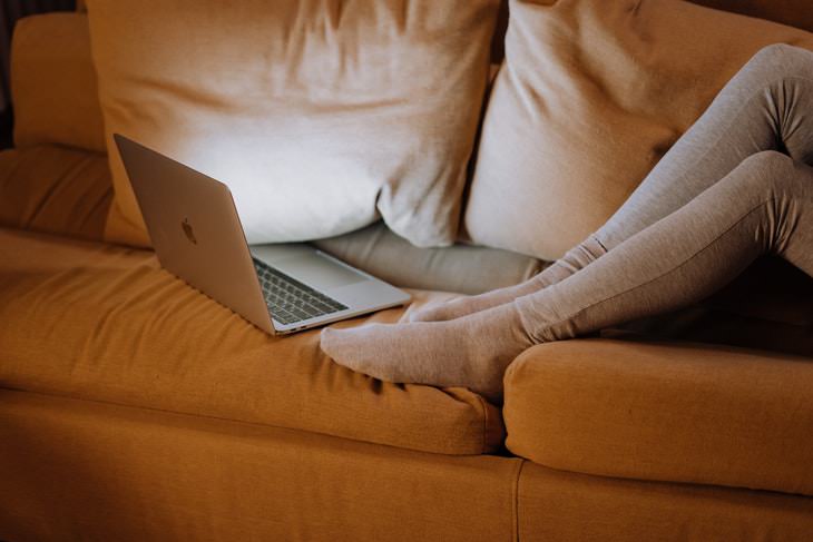 coffee overdose laptop at night couch legs