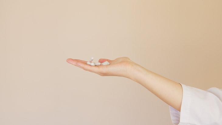 Natural Ways to Increase Dopamine Levels hand with pill