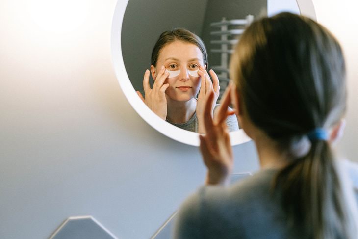 Dark Circles Causes and Tips woman putting on eye patches